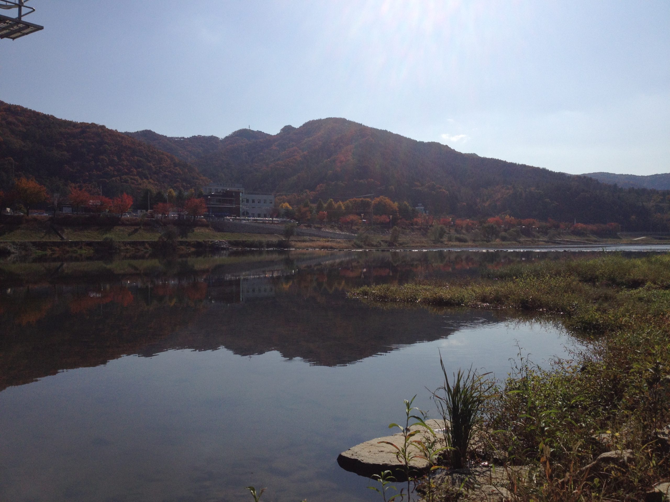 photo of river and mountains with building in background